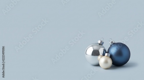 A group of silver and blue Christmas baubles isolated on a white background. Perfect for festive holiday greeting cards, seasonal banners, and web decor.