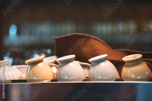 Ceramic cups placed upside down on a tray with soft ambient lighting.