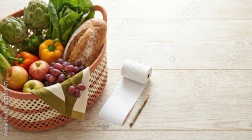 Grocery Basket of Fresh Produce Beside Store Receipt on Table