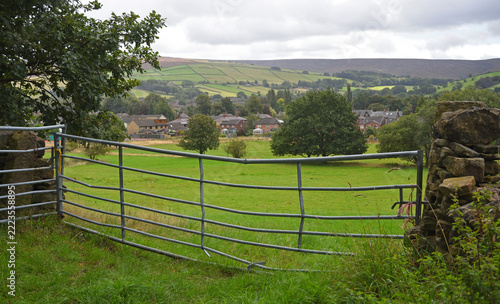 Galvanised metal field gate set in a rural stone wall over looking Glossop  Derbyshire