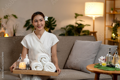 Smiling Spa Receptionist Sitting on Sofa with Clipboard in Cozy Wellness Lounge