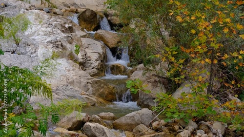 Scenic Woodland Creek with Multiple Cascades in Autumn. Tiered Waterfalls Flowing Through an Autumn Forest Stream. Small Cascading Waterfalls in a Colorful Fall Woodland.