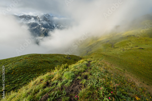 Footpath on grassy Kori ridge with Himalayan peaks, Nepal