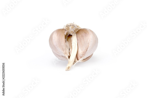 Split open garlic bulb on clean white background surface
