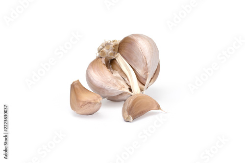 Garlic bulb with loose cloves on white background