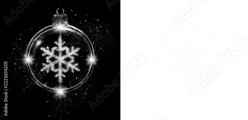 Christmas bauble with detailed white snowflake inside glowing glass on black and transparent background