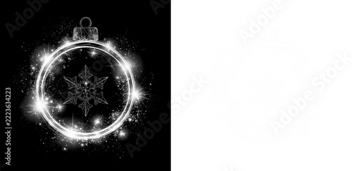 Glowing ring Christmas bauble with dark snowflake and sparkling dust on black and transparent background