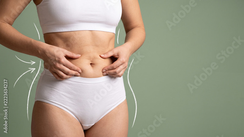 Woman Pinching Belly Fat in White Underwear with Chalk Arrow Lines Showing Weight Loss, Body Contouring and Slimming Concept