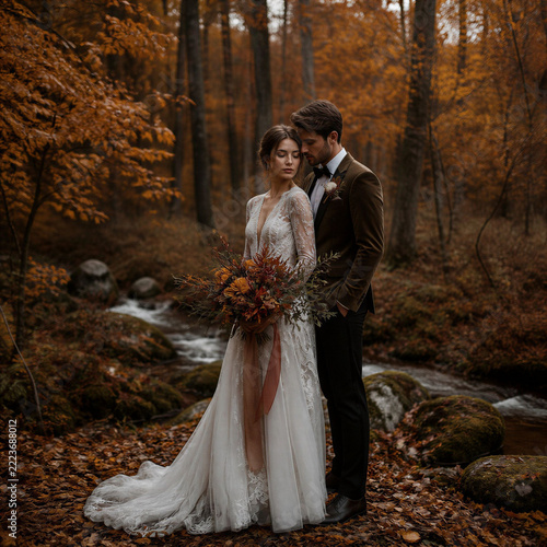 bride and groom in autumn forest 