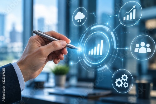 Hand holding a pen near a glowing analytical interface with cloud and personnel icons