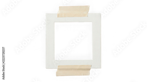 Square paper photo frame held by adhesive tape isolated on a