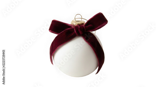 White christmas ornament with burgundy velvet bow isolated on
