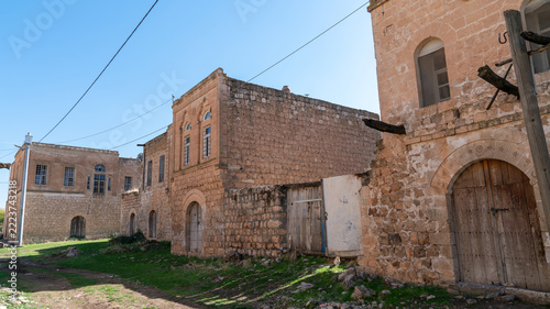 Old cut stone mansions with arched wooden doors in Dereici, also known as Killit, an abandoned Syriac village near Savur, Mardin, Turkey