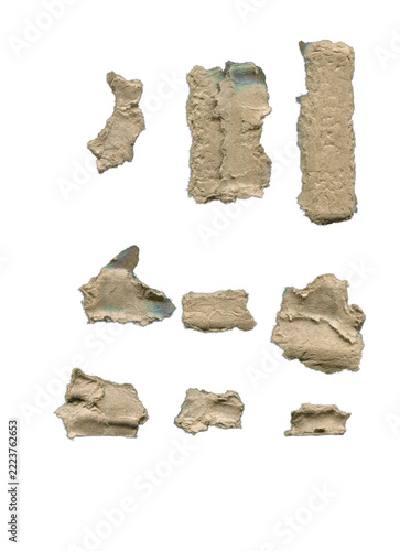 Set of torn brown cardboard pieces with ripped rough edges isolated on white background