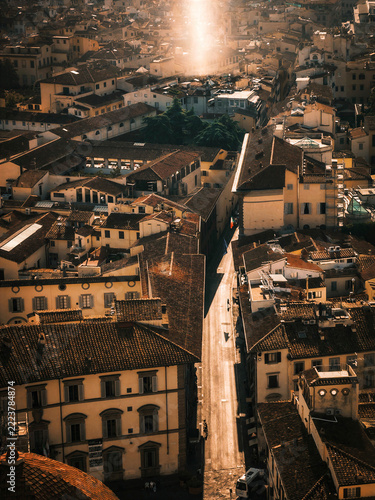Obraz na plátně Historic Italian city rooftops glowing in warm evening sunlight