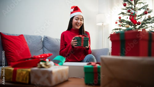 Happy Woman Celebrating Christmas with Gifts and Christmas Tree