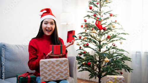 Happy Woman Celebrating Christmas with Gifts and Christmas Tree
