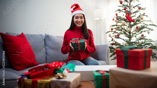 Happy Woman Celebrating Christmas with Gifts and Christmas Tree