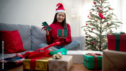 Happy Woman Celebrating Christmas with Gifts and Christmas Tree