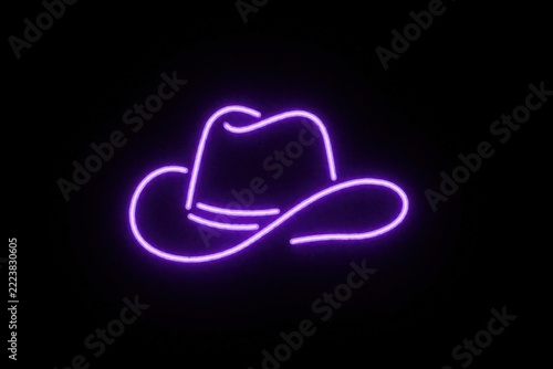 Purple neon cowboy hat outline on black background. Glowing violet western hat symbol in bright electric light. Minimalist rodeo headwear icon for country music party, disco night club event wild
