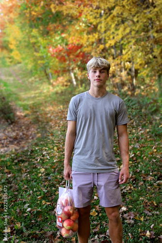 Teenage Boy Outside at Apple Orchard in the Fall