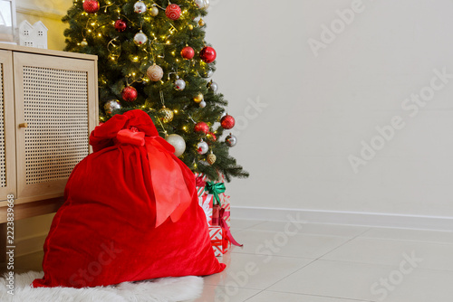Christmas gift delivery and holiday celebration, large red velvet Santa Claus...