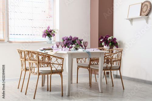 Home interior design and spring dining, table setting with lilac flowers and ...
