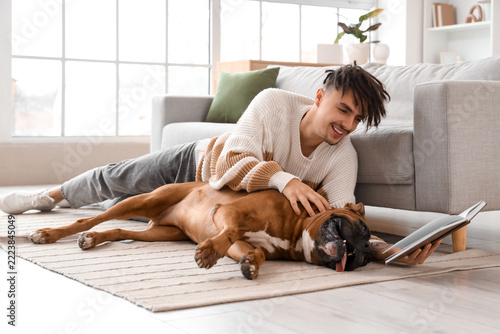 Work-life balance and mental health, young man relaxing at home with his dog ...