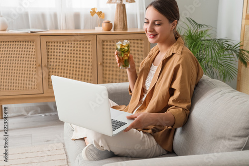 Remote work and work-life balance, happy woman using laptop and drinking iced...
