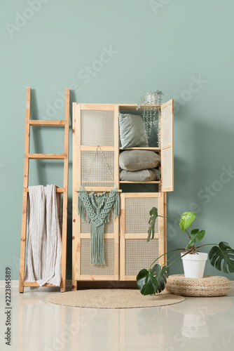Interior design and home decor, wooden cabinet with rattan doors and decorati...