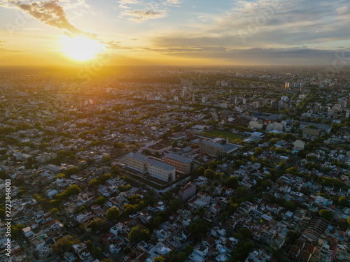 Drone view of Villa Devoto prison complex and urban city skyline during golden hour