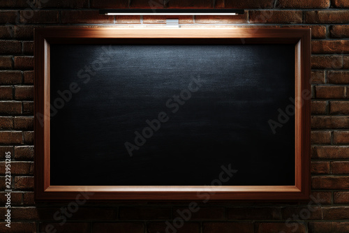 clean view of a dark chalkboard slate within a smooth, modern walnut frame, set against a perfectly laid brick wall and LED light background.