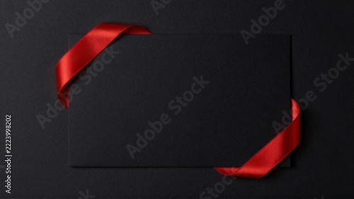 Black friday and cyber monday sale concept with dark paper and red ribbon