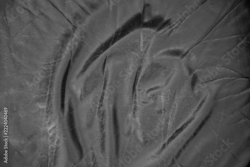 Full frame close-up view of the surface of a black leather couch