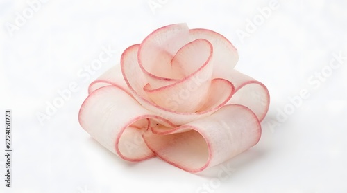A beautifully crafted delicate pink and white fabric flower is isolated on a white background perfect for various craft projects and elegant decorative designs