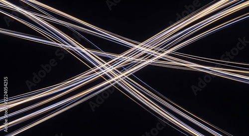Abstract light trails forming a crossing pattern against a dark black background
