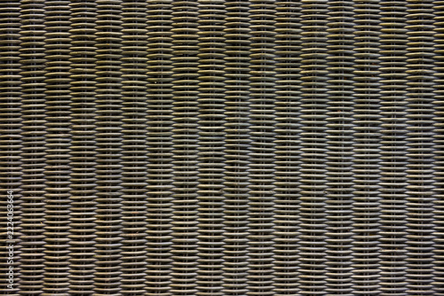 Close Up Woven Rattan Texture Background. Detailed close-up of dark natural rattan weaving with an intricate repeating pattern, ideal as a rustic material texture background.