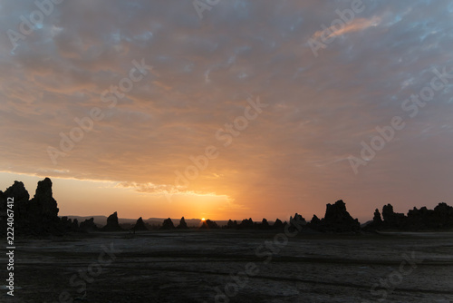 Sunrise over limestone chimneys under a dramatic cloudy sky, Lake Abbe, Djibouti