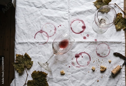 Red wine stain rings on white linen tablecloth