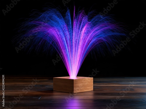 Glowing fiber optic strands emanate from a wooden cube on a wooden floor.