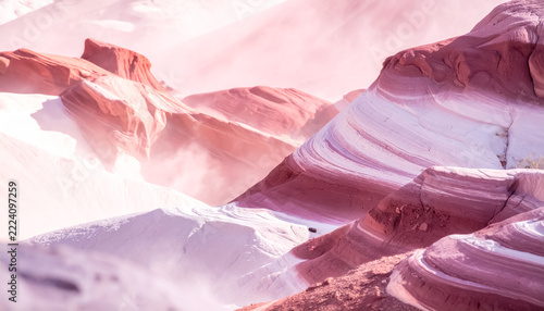 Surreal Pink and White Layered Rock Formations in Misty Desert