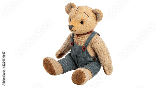 Classic vintage brown teddy bear plush toy wearing denim overalls pants, isolated on transparent background.
