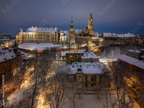 Snowy evening aerial view of Wawel Castle and Planty Park in Krakow, Poland, with warm street lights