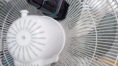 Close-up, A vacuum cleaner being used to remove dirt and dust from a floor fan, negatively affect the respiratory system.