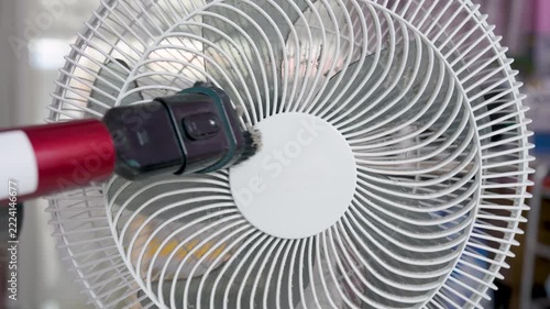 Close-up, A vacuum cleaner being used to remove dirt and dust from a floor fan, negatively affect the respiratory system.