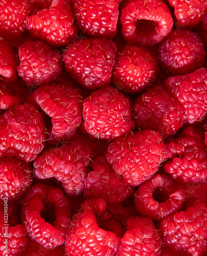 Fresh ripe red raspberry berries close up textured background