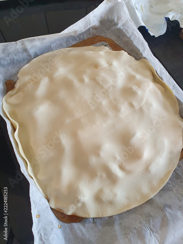 Homemade Unbaked Pie Covered With Pastry Dough Ready For Baking On Parchment Paper