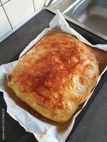 Golden Baked Puff Pastry Meat Pie On Baking Tray With Homemade Flaky Crust