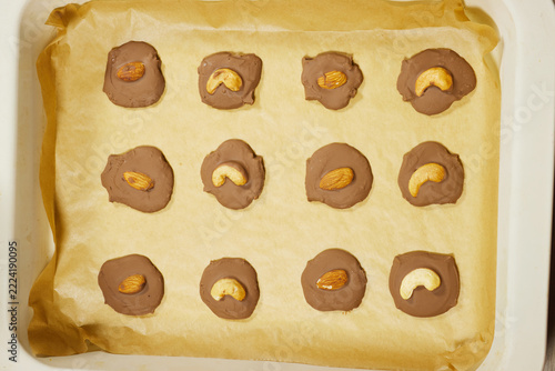 Chocolate Nut Candies on Parchment Paper in Baking Tray Ready to Set and Cool