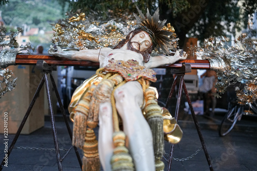 Close-up of a processional crucifix carried by a confraternity during a religious procession in Liguria, Italy